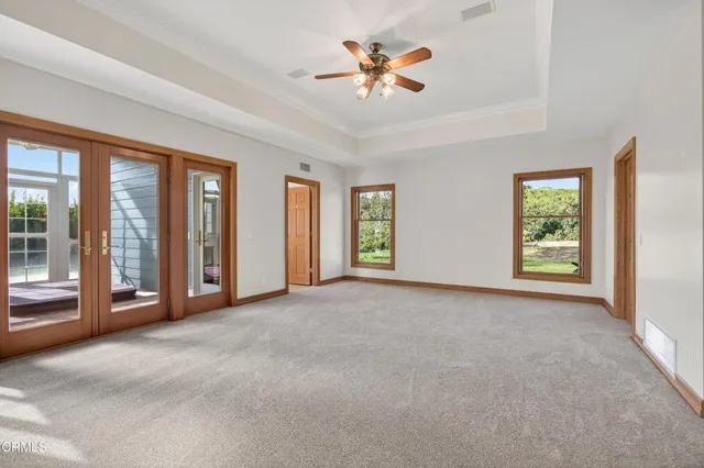 a living room with furniture a fireplace and a floor to ceiling window