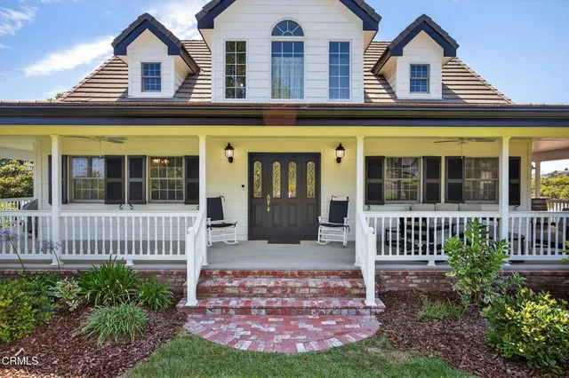 a very nice looking hallway with wooden floor and a chandelier