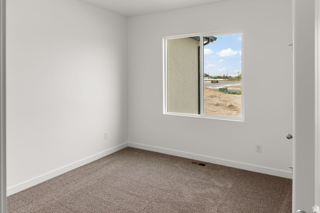 1417 West 2350th South, Unit 14 Perry, UT 84302 - Photo 10 of 19 Neutral tone interior space with white walls and trim