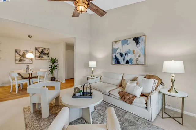 a bathroom with a granite countertop sink toilet and mirror
