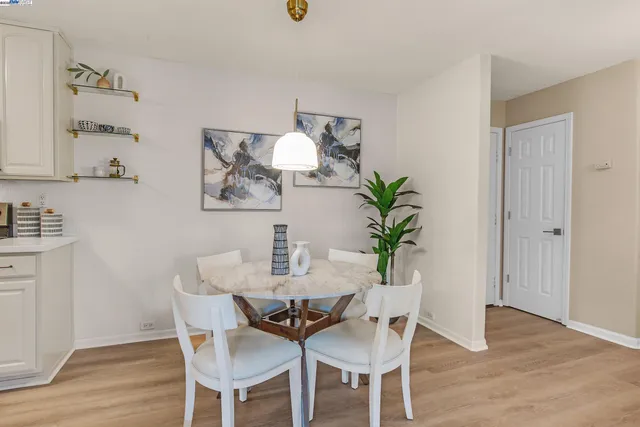 a view of a dining room with furniture and wooden floor