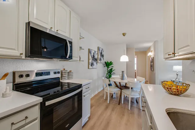 a living room with furniture a chandelier and a window