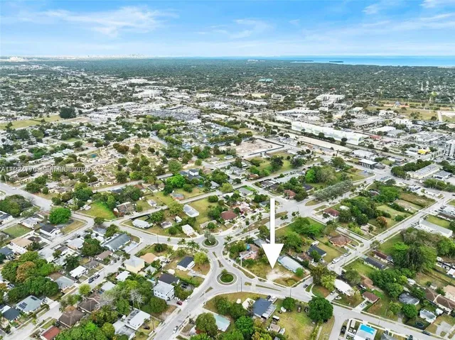 an aerial view of residential houses with city view