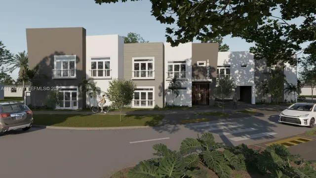 a front view of a house with a yard and tree s