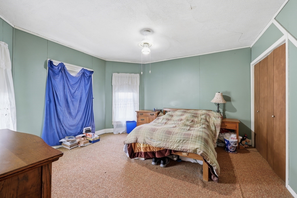 84 Middlefield Road Chester, MA 01011 - Photo 22 of 36 a bedroom with a bed and a table in it