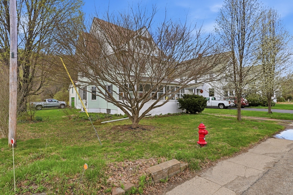 84 Middlefield Road Chester, MA 01011 - Photo 4 of 36 a view of white house with a yard and tree