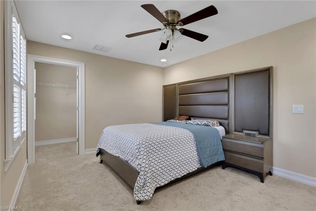 16309 Aberdeen Way Naples, FL 34110 - Photo 24 of 34 a bedroom with a bed and a ceiling fan