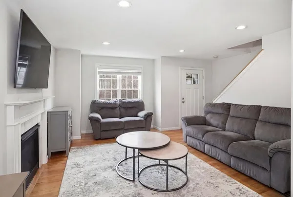 a living room with furniture a fireplace and a flat screen tv