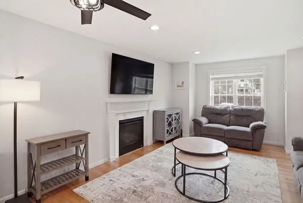 a living room with furniture a rug and a fireplace