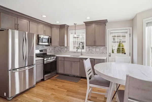 a kitchen with stainless steel appliances granite countertop a refrigerator stove microwave and sink