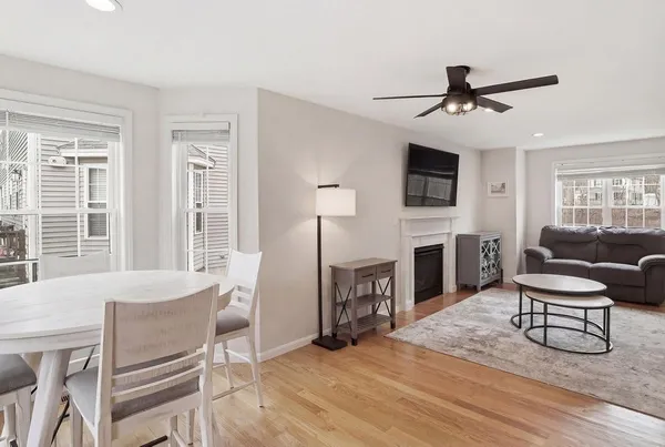 a living room with furniture a fireplace and a flat screen tv