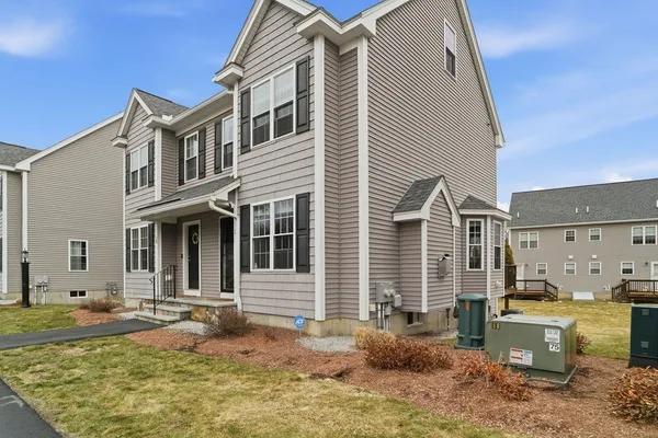 a view of a house with backyard and sitting area