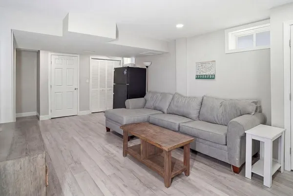 a living room with furniture and a wooden floor