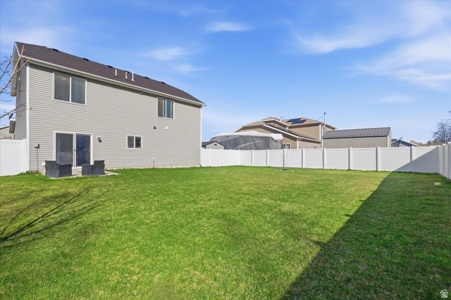 1084 South 740 East Logan, UT 84321 - Photo 15 of 23 Rear view of property with a fenced backyard
