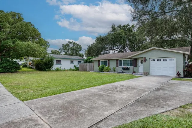 a front view of house with yard and green space