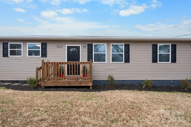 a view of a house with wooden deck