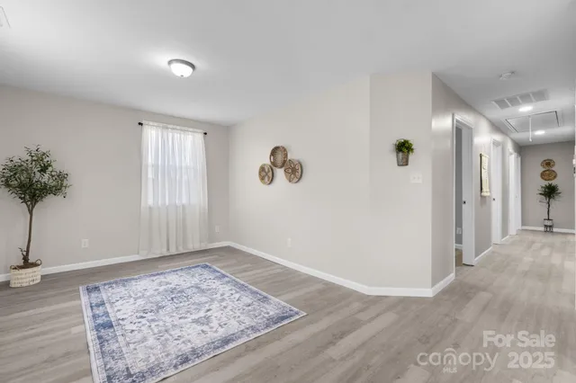 an empty room with window and wooden floor