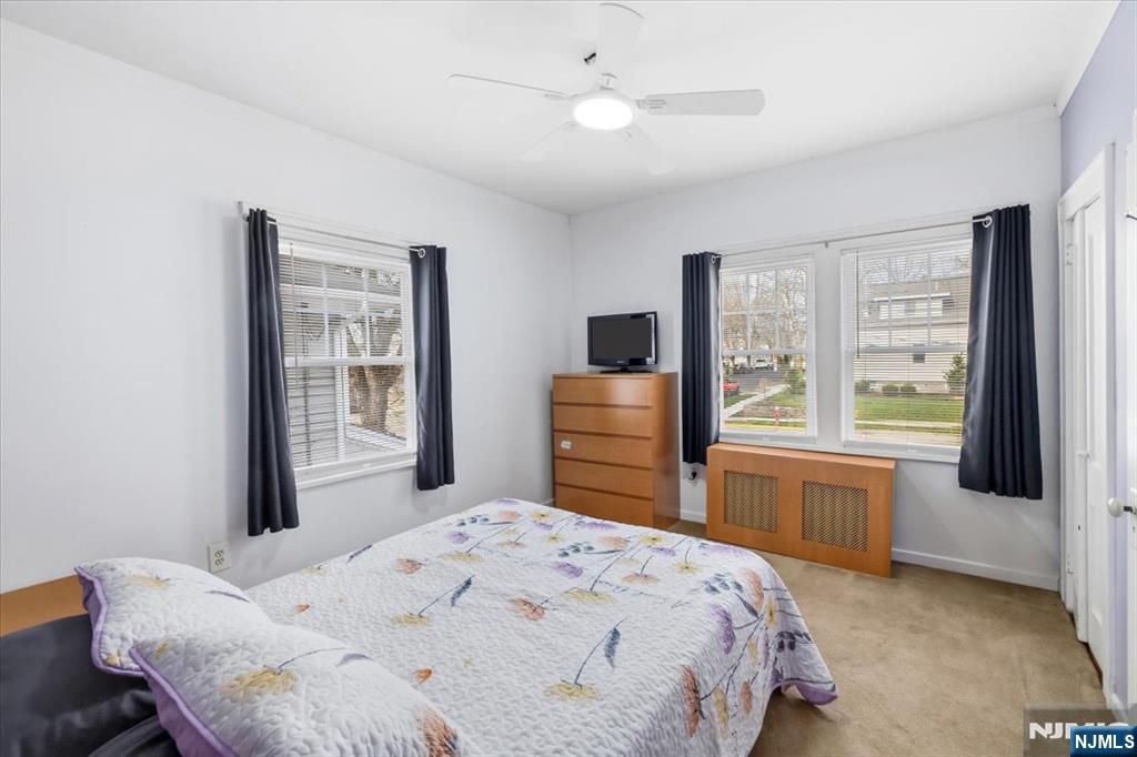119 Overpeck Avenue Ridgefield Park, NJ 07660 - Photo 18 of 44 a bedroom with a bed dresser and a large window
