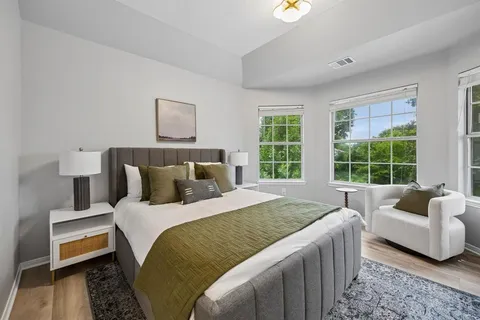 a bedroom with a bed and a window