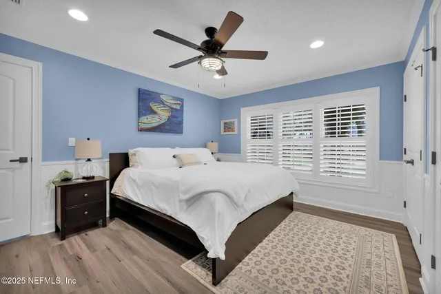 a front view of a house with a garden and trees