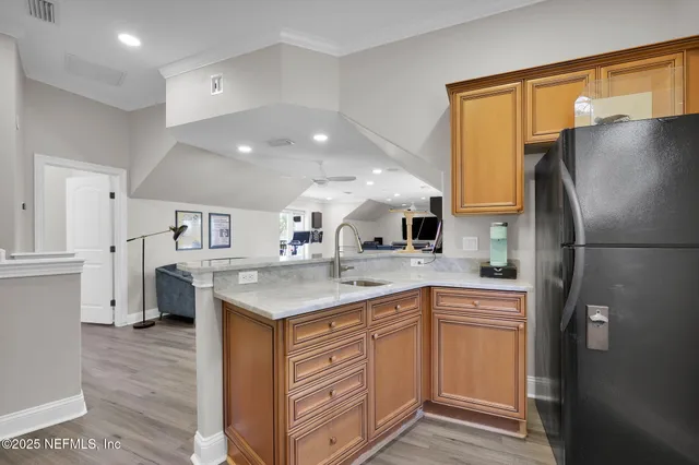 a living room with furniture a flat screen tv and a floor to ceiling window
