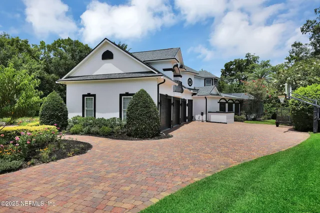 a front view of house with yard and green space