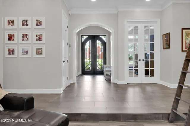 a view of a dining room with furniture and chandelier