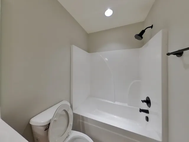a bathroom with a shower and toilet