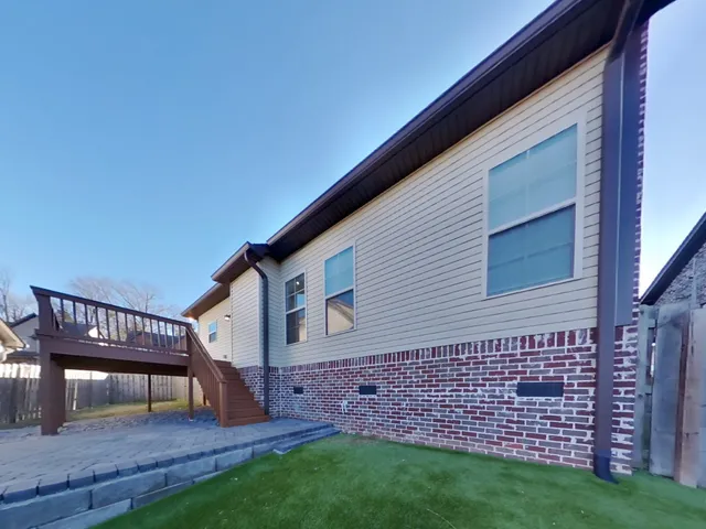 a view of a backyard with table and chairs