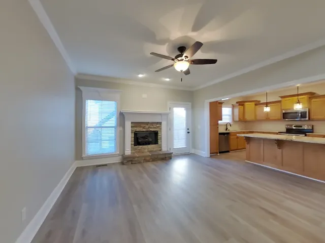 an open kitchen with sink and stainless steel appliances with cabinets