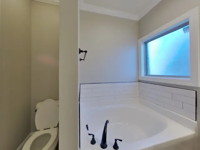 a bathroom with a toilet and bathtub