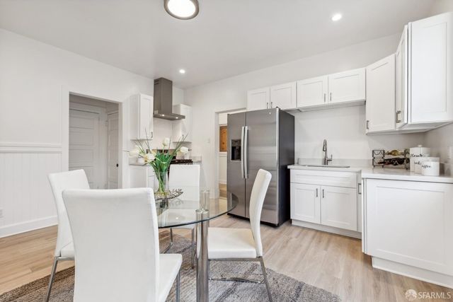 a kitchen with stainless steel appliances a refrigerator and a stove top oven