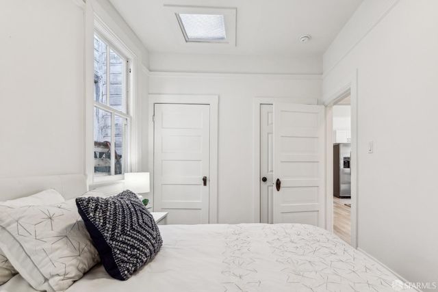 a bedroom with a bed and a couch