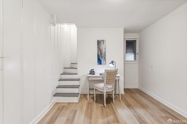 a dining room with furniture and wooden floor