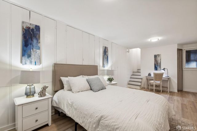 a bedroom with a bed and a lamp on table