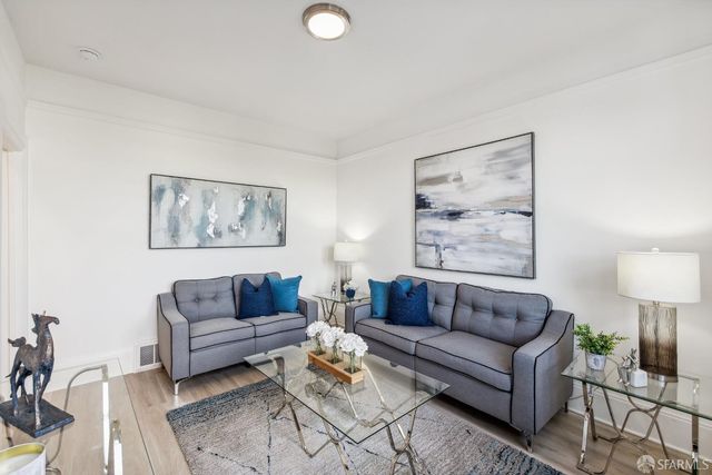 a living room with furniture and a lamp
