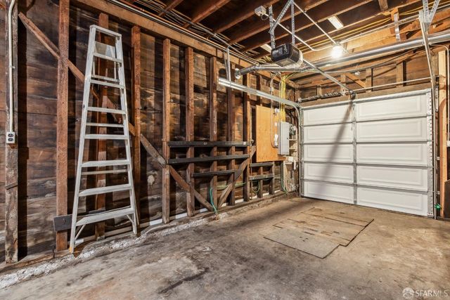 a view of an empty room with wooden shelves