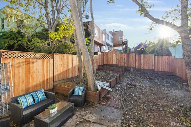 a backyard of a house with outdoor seating