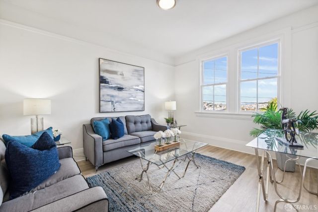 a living room with furniture and a potted plant