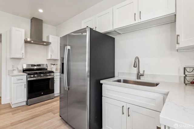 a kitchen with stainless steel appliances a refrigerator sink and stove