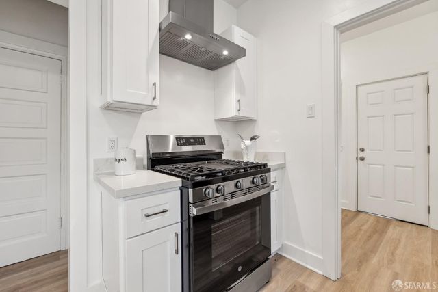 a kitchen with stainless steel appliances granite countertop a stove and a refrigerator