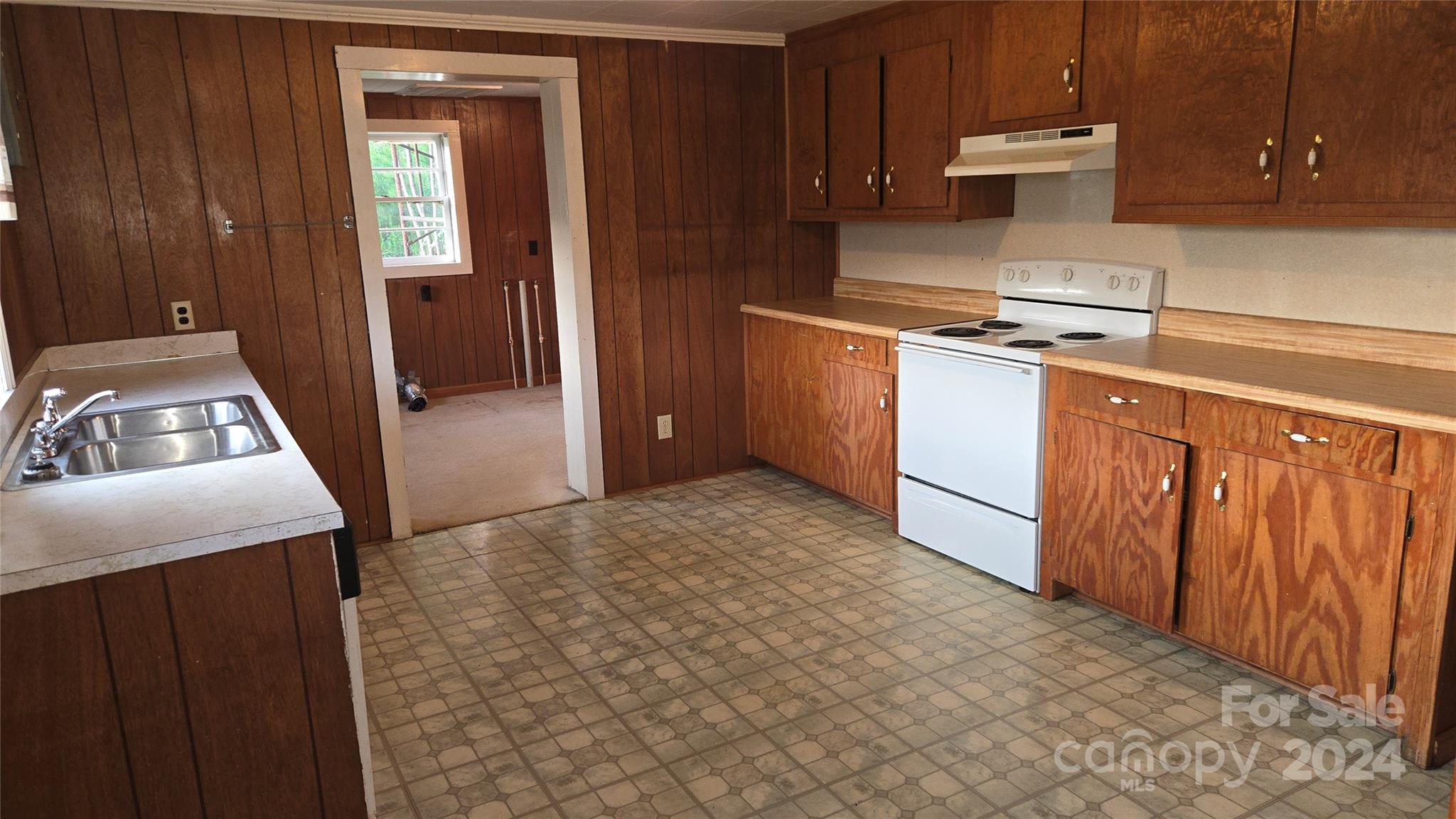 127 Lake Adger Road Mill Spring, NC 28756 - Photo 8 of 20 a kitchen with a refrigerator stove and cabinets