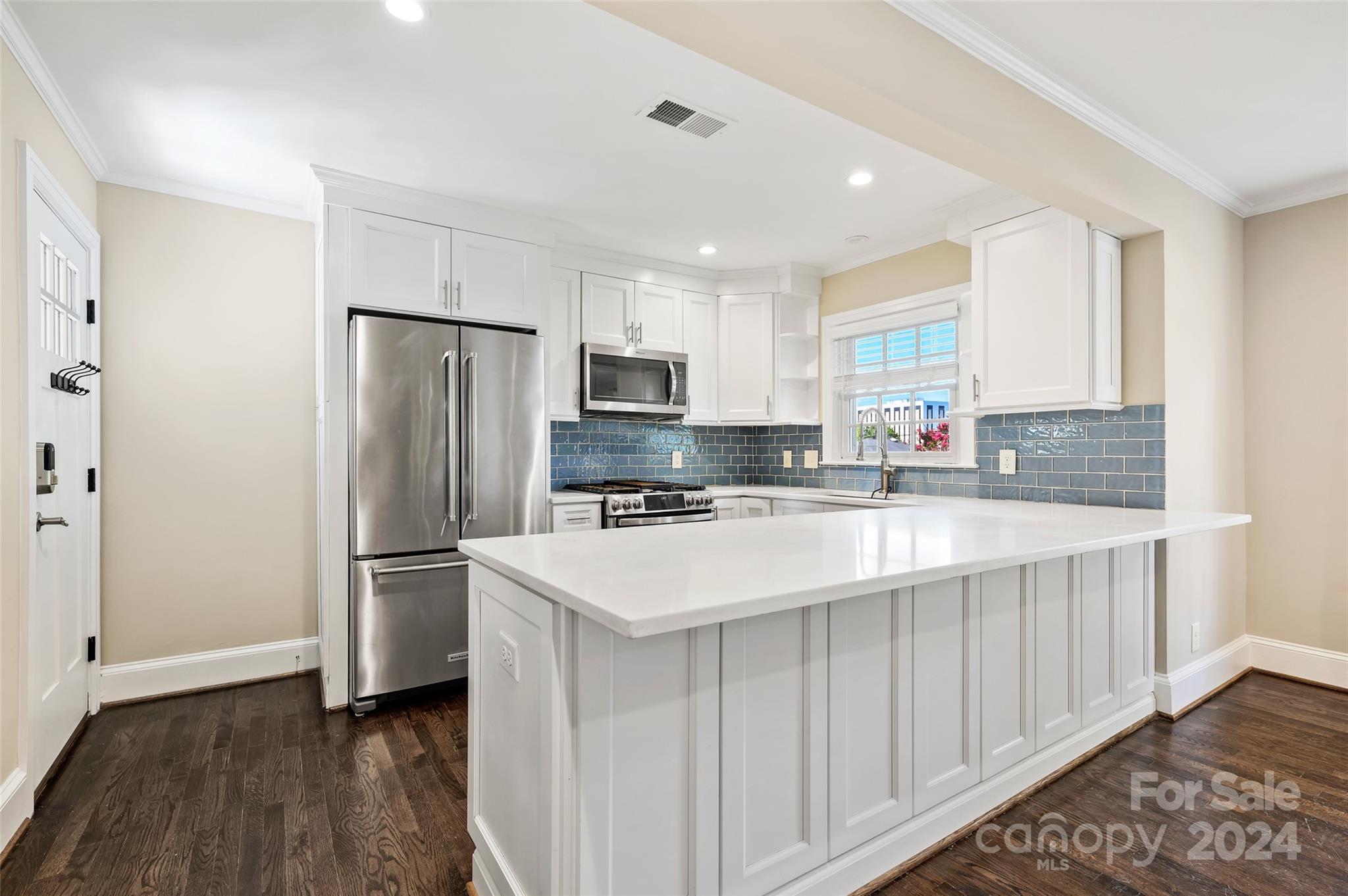 3233 Pinehurst Place Charlotte, NC 28209 - Photo 13 of 39 a kitchen with refrigerator cabinets and wooden floor
