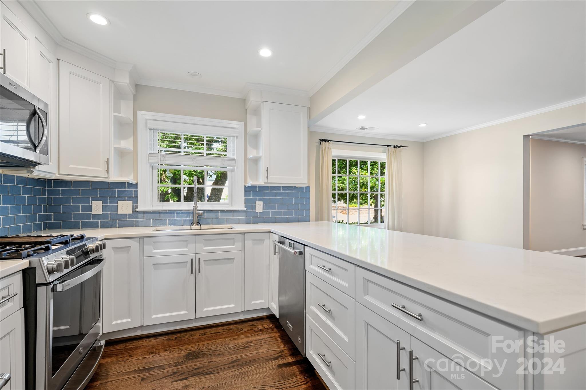 3233 Pinehurst Place Charlotte, NC 28209 - Photo 14 of 39 a kitchen with a sink stove and cabinets
