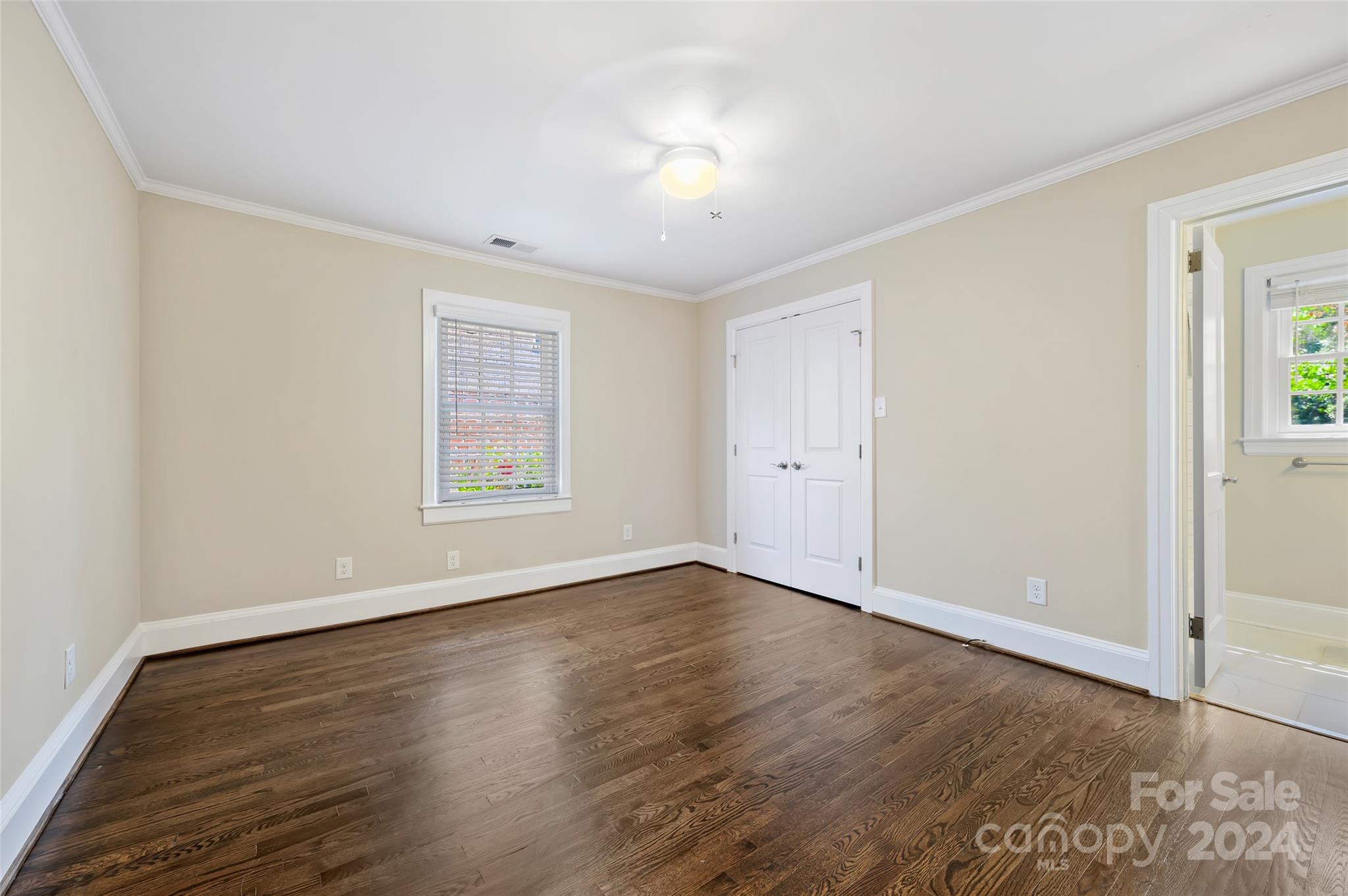 3233 Pinehurst Place Charlotte, NC 28209 - Photo 16 of 39 a view of an empty room with wooden floor and a window