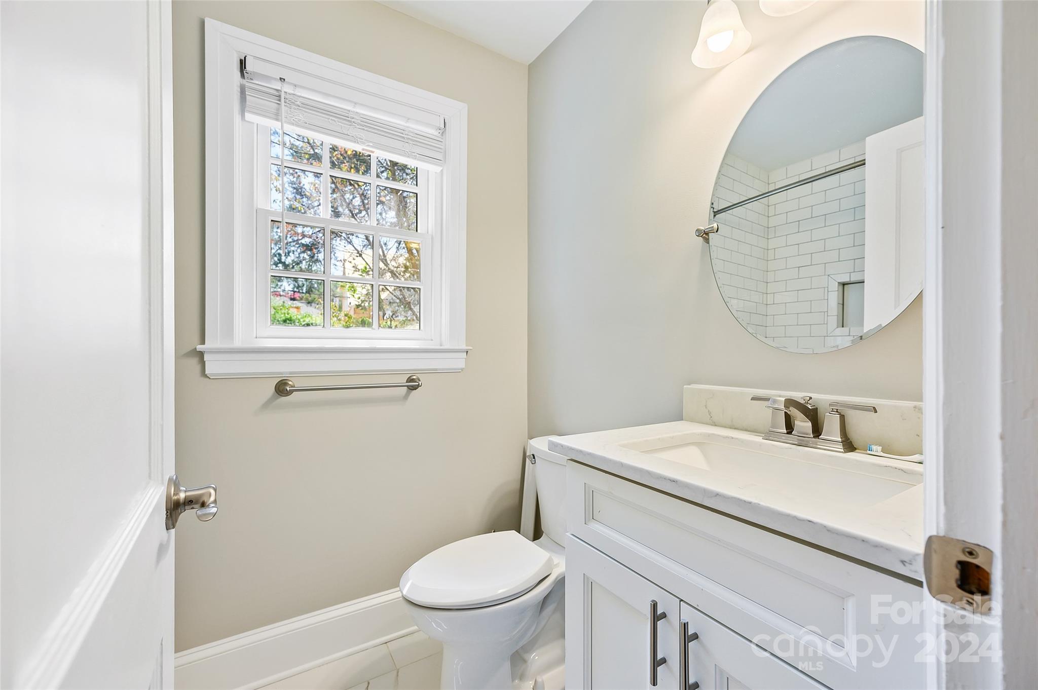 3233 Pinehurst Place Charlotte, NC 28209 - Photo 18 of 39 a bathroom with a sink toilet and a mirror