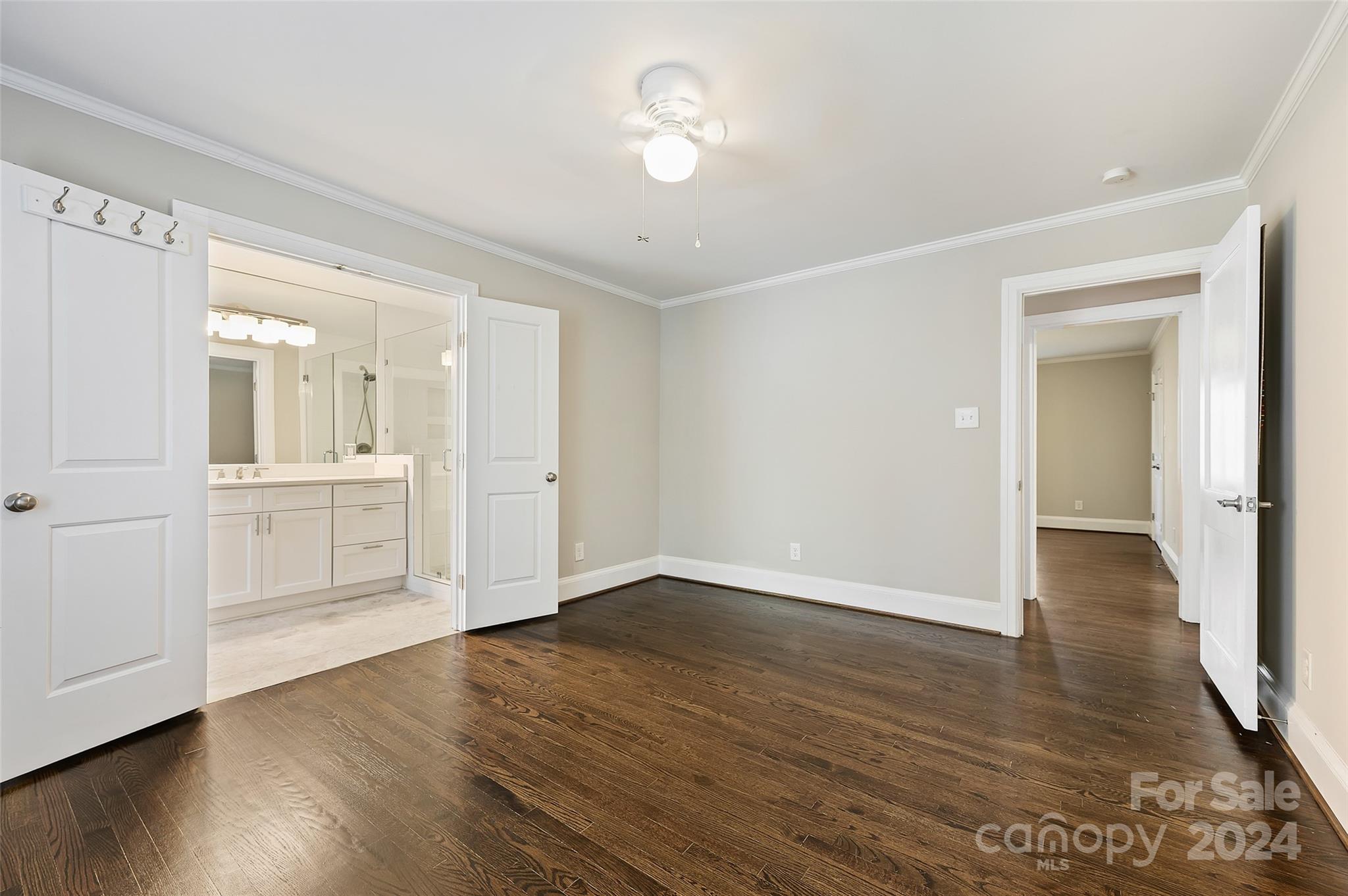 3233 Pinehurst Place Charlotte, NC 28209 - Photo 20 of 39 a view of an empty room with wooden floor and a kitchen