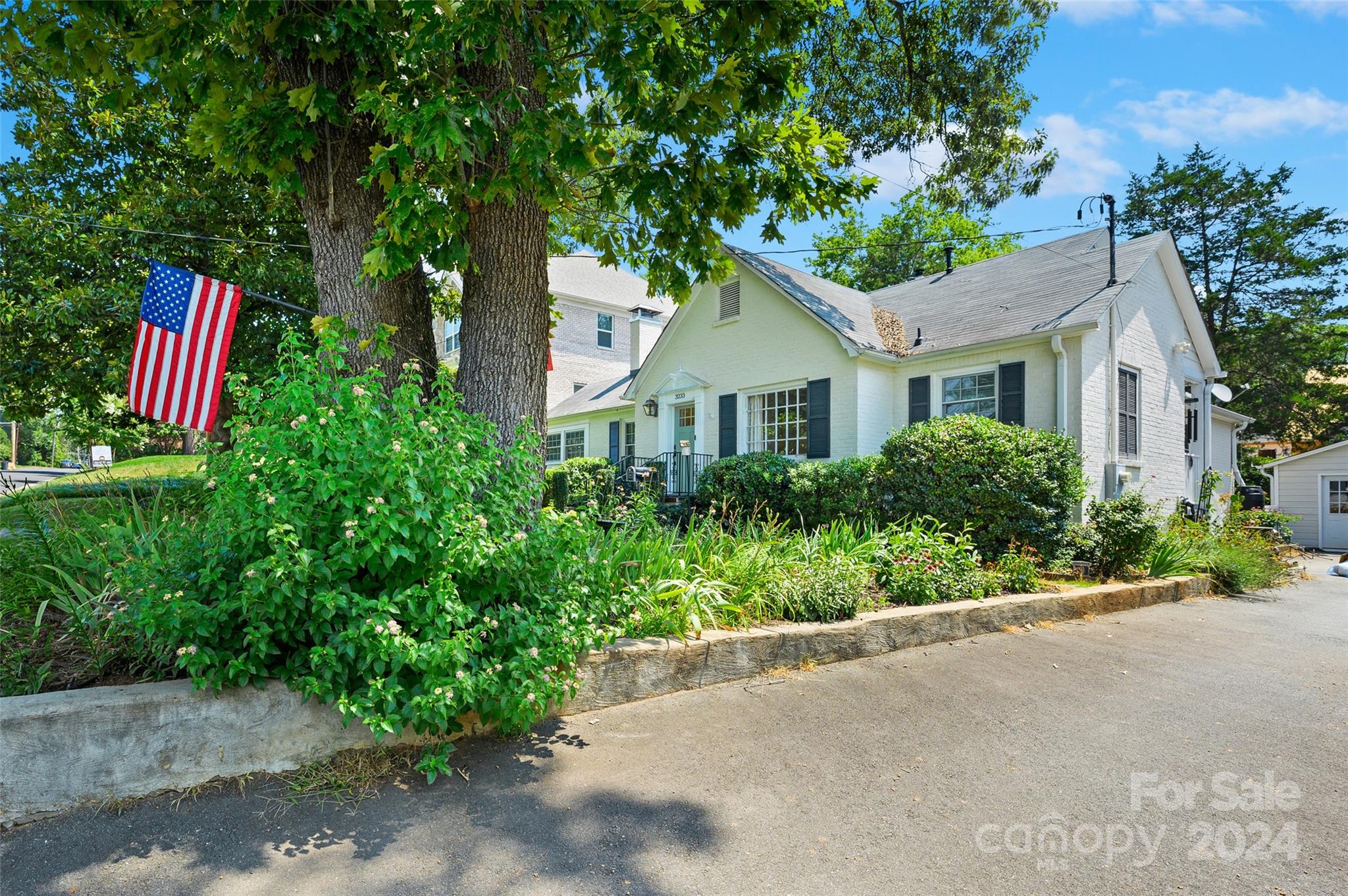 3233 Pinehurst Place Charlotte, NC 28209 - Photo 2 of 39 a front view of a house with a garden