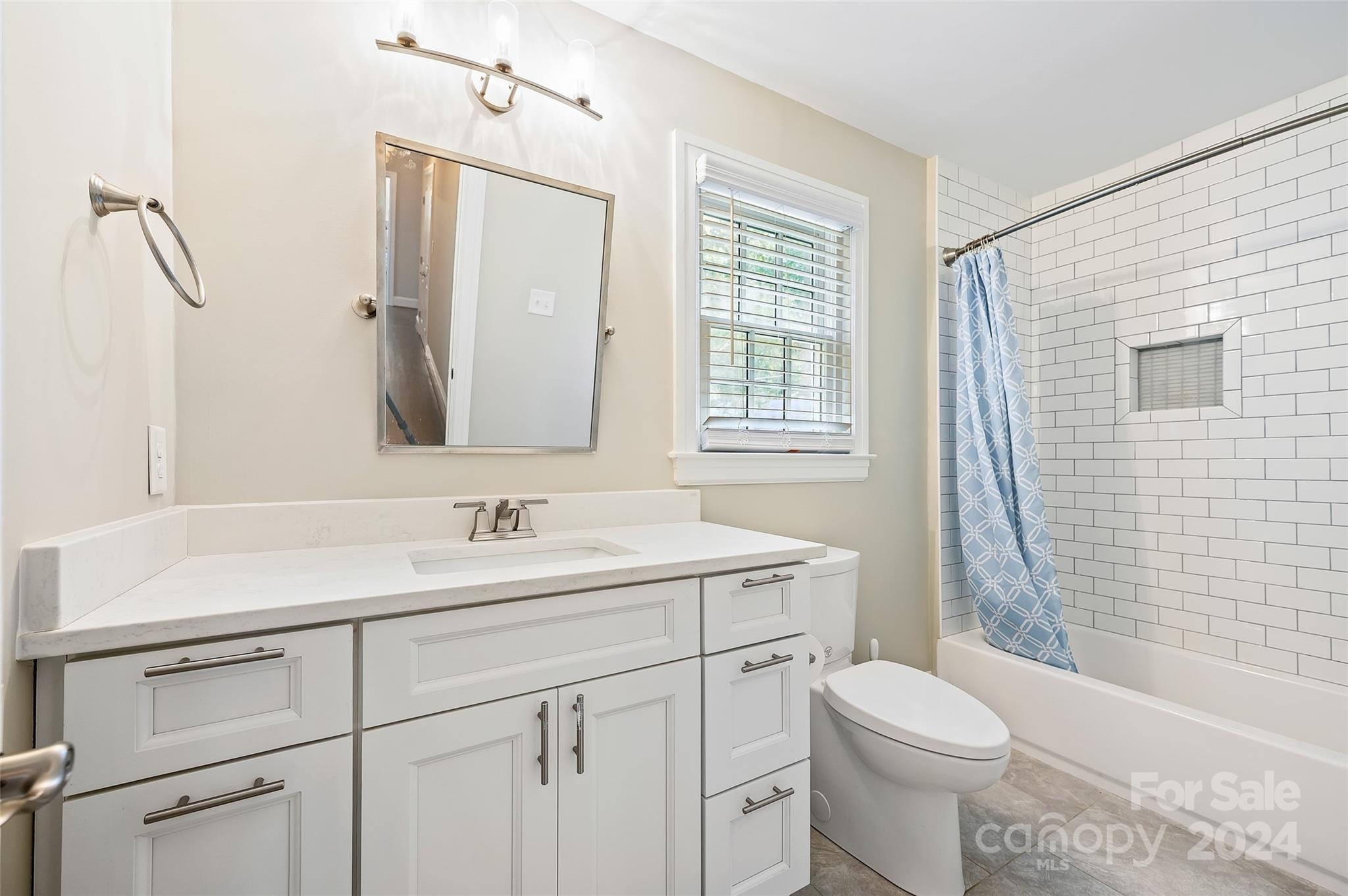 3233 Pinehurst Place Charlotte, NC 28209 - Photo 23 of 39 a bathroom with a sink a toilet and shower
