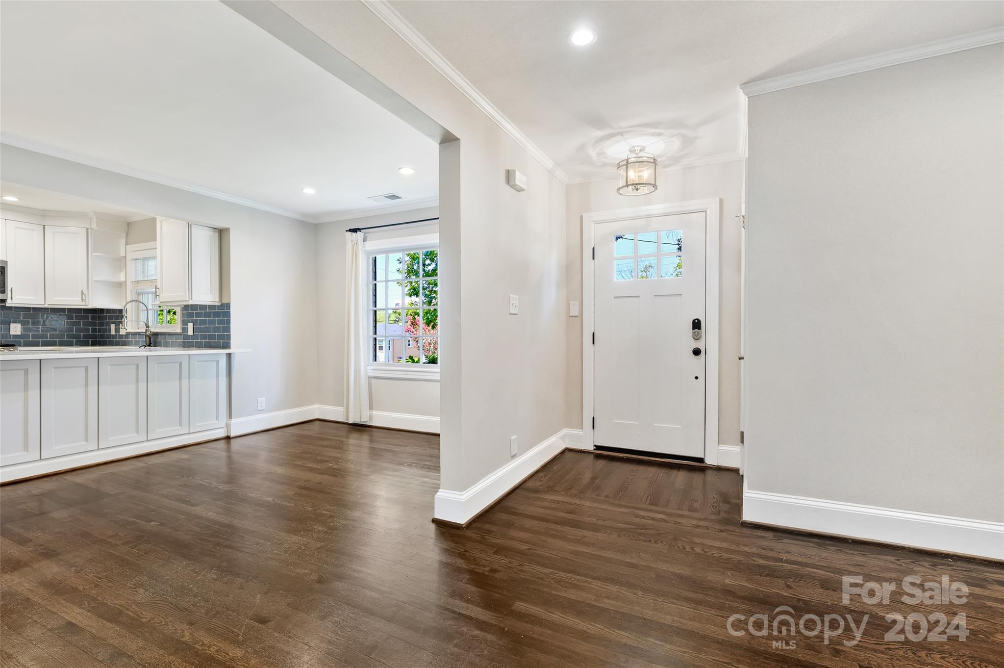 3233 Pinehurst Place Charlotte, NC 28209 - Photo 3 of 39 an empty room with wooden floor and windows